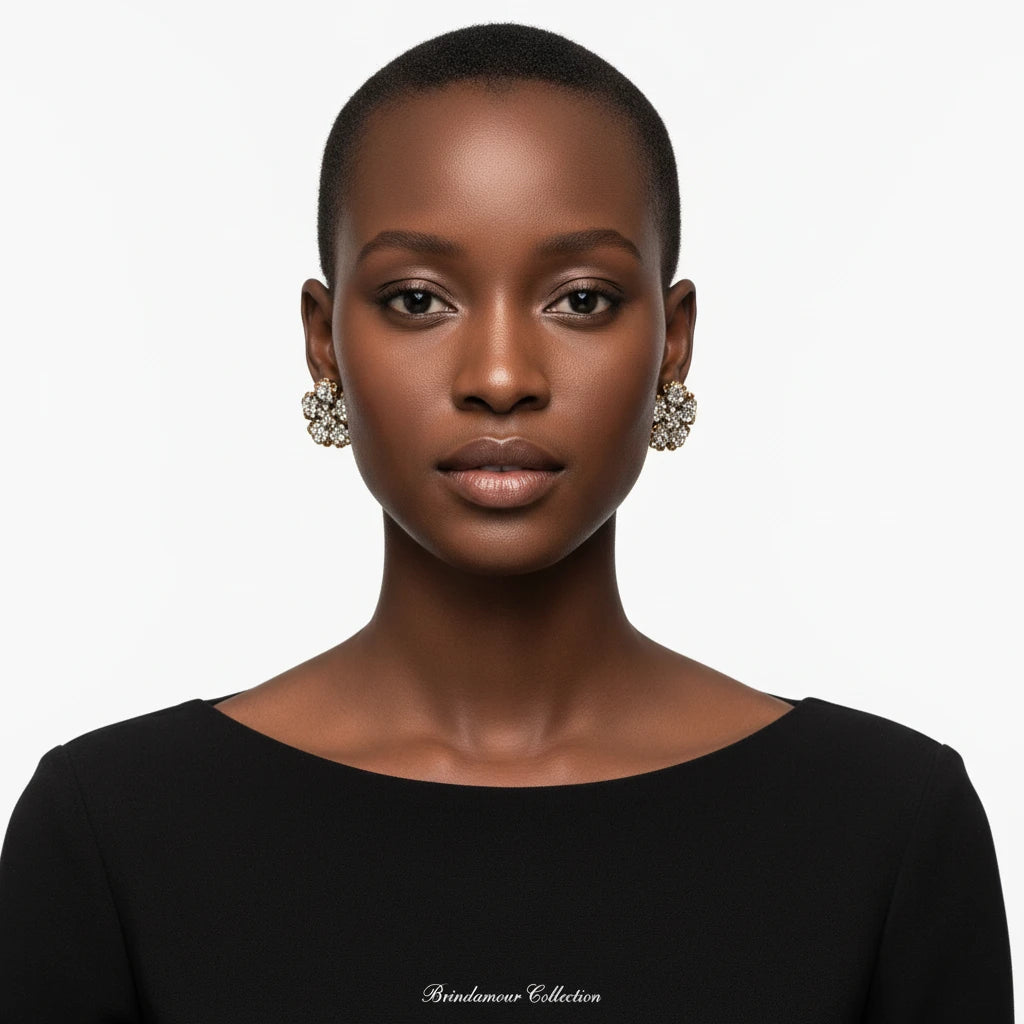 Ornate gold-plated flower earrings with clear zirconia crystals arranged in dimensional petal formations on cream background.